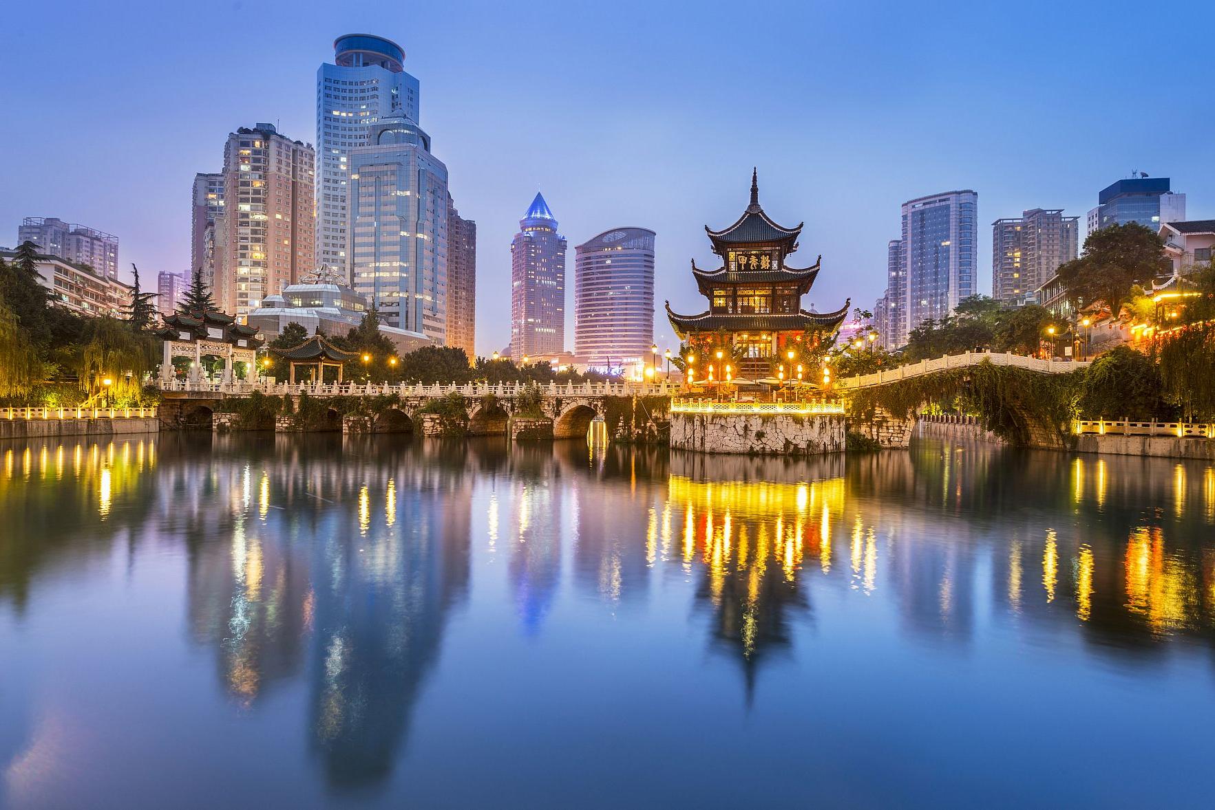 Cityscape of Guiyang at night, Jiaxiu Pavilion on the Nanming River. Located in Guiyang City, Guizhou Province, China.